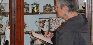 Liz studying the ceramics at Kirkcaldy Museum & Art Gallery. Photography: Artists Own